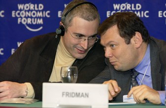 Chairman of the directors' board of the alpha-bank js mikhail fridman with khodorkovsky at the world economic forum.
