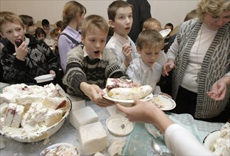 Nizhni novgorod,russia, december 17, 2003, children from orphanage no,23 taste with great pleasure a huge 200kg ice-cream in a shape of a castle which was presented to them as a gift by cooks of the l...
