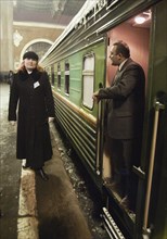 Moscow, russia, january 21, 2004, conductor margarita matveeva (l) stands near her new car of the luxury class of the 'tatarstan' train ready for leaving for kazan from kazan railway station of moscow...