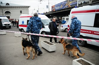 Moscow, russia, march 29, 2010, dog handlers and ambulances outside park kultury metro station, sokolnicheskaya line of the moscow underground, an explosion rocked the metro station at 8,40 during the...