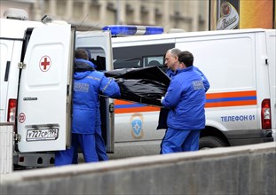Moscow, russia, march 29, 2010, rescue workers carry the body of a bombing victim into an ambulance outside park kultury metro station, sokolnicheskaya line of the moscow underground, an explosion roc...