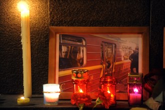Moscow, russia, march 30, 2010, a photograph of a damaged metro carriage and candles to commemorate victims of the metro bomb explosions, blasts rocked two stations on sokolnicheskaya line of the mosc...
