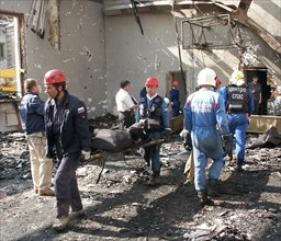 North ossetia, russia, september 4, 2004, russian emergency workers remove victims' bodies from the debris of the school in beslan.