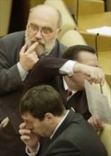 A state duma deputy sergei popov (in the background) during the plenary session of the state duma on novemver 17.