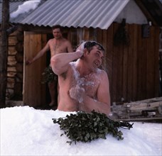 Two men taking a snow bath after the siberian sauna, altai region, russia, 1983.