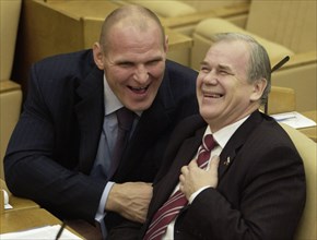 Members of the 'united russia' faction in the state duma alexander karelin and sergei popov (l-r) at the plenary session of the lower house of the russian parliament on friday december 10.