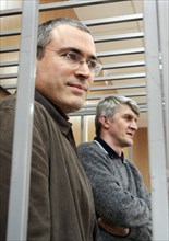Moscow, russia, march 28, 2005, former yukos ceo mikhail khodorkovsky (l) and his partner platon lebedev stand behind bars as they listen to a prosecutor during their trial in moscow, monday, march 28...