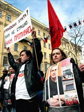 St,petersburg, russia, april 24, 2005, a participant in the action holds up a placard reading 'kremlin junta! we are not scared, we are disgusted' during an action in support of mikhail khodorkovsky, ...
