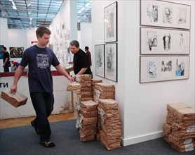 Moscow, russia, may 24, 2005, a stand (r) with drawings made by pavel shevelev (l) during a trial of mikhail khodorkovsky and platon lebedev, drawings on khodorkovsky-lebedev trial are exhibited in th...