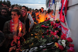 Yaroslavl, russia, september 7, 2011, lokomotiv yaroslavl fans lay flowers outside arena-2000 stadium to commemorate players of a khl ice hockey team lokomotiv who died in a yak-42 passenger plane cra...
