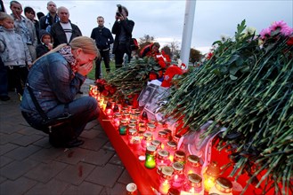 Minsk, belarus, september 9, 2011, people lay flowers and light candles outside minsk-arena stadium to commemorate hc lokomotiv yaroslavl team players who died in a plane crash on september 7, a khl g...