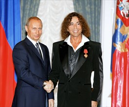 Russian president vladimir putin (left) presents a state award to singer valery leontyev, moscow, russia, july 25, 2005.