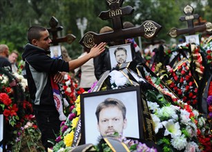 Yaroslavl, russia, september 10, 2011, relatives and fans grieve during the funeral of 14 hc lokomotiv yaroslavl players at leontyevskoye cemetery, a yakovlev yak 42 charter flight, which was to take ...
