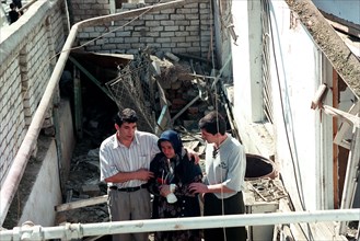 Makhachkala, russia, september 7, 1999, rescue workers pictured rendering help to an old woman at the place of accident as the death toll from a blast in a 5-storey dwelling house in the daghestani to...