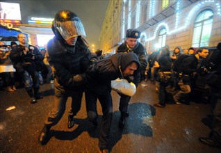 Moscow, russia, december 5, 2011, riot police detain demonstrators during an opposition protest in central moscow against alleged vote-rigging in the december 4 parliamentary election.