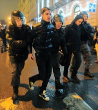 Moscow, russia, december 5, 2011, riot police detain young demonstrators during an opposition protest in central moscow against alleged vote-rigging in the december 4 parliamentary election.