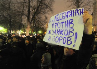 Moscow, russia, december 5, 2011, a demonstrator holds a banner reading 'gay men and lesbians are against swindlers and thieves' during an opposition protest in central moscow against alleged vote-rig...
