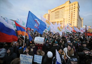 Moscow, russia, december 12, 2011, demonstrators wave flags during a rally staged by pro-kremlin youth groups in central moscow, the event took place two days after a mass protest against alleged vote...