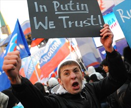 Moscow, russia, december 12, 2011, a young demonstrator holds up a sign reading in putin we trust during a rally staged by pro-kremlin youth groups in central moscow, the event took place two days aft...