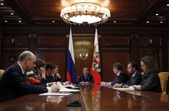 Moscow region, russia, december 13, 2011, president of russia dmitry medvedev (background) holds a meeting with officials from the government