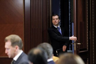 Moscow region, russia, december 13, 2011, president of russia dmitry medvedev (background) arrives for a meeting with officials from the government, presidential administration and the expert communit...