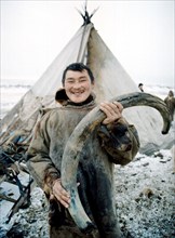 Viktor yarotsky holds a mammoth tusk weighing 12 kg which was found near the yara-tanam river, taimyr residents quite often find remains of the prehistorical animals, mammoth ivory is used by local ma...