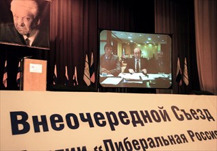 Moscow, russia, june 14, 2003, boris berezovsky (on screen, centre) delivering a report via tv bridge from london for the special congress of the liberal russia party, held at the kosmos hotel in mosc...