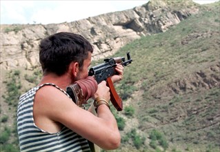 Makhachkala, daghestan, russia, august 12, a daghestani militiaman watch the mountains in the tsumadinsky district,from where chechen gunmen may appear ,the chechen militants who suffered considerable...