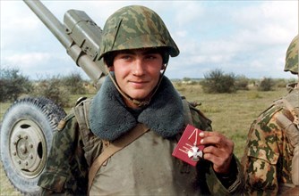 Chechnya, russia, october 27, 1999, gun layer, jr, sgt, yevgeny frankiv pictured showing the order of courage he was awarded with by commander of the eastern grouping of the russian federal armed forc...