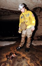 Vadim mikhailov, leader of the organization, diggersof planet underground, with a dead bird found while inspecting underground communication lines, moscow, russia, december 8, 1999.