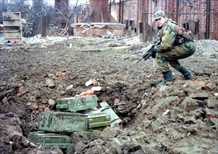 A russian sapper prepares to destroy mines and shells found at house wreckages in the chechen capital of grozny, during the last 24 hours about 2,000 mines and fougasses have been found and defused in...