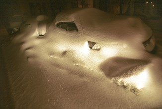 Moscow, russia, february 28, 2001, cars parked in a moscow courtyards (in pic) are almost lost in snowdrifts, last night's snowfall added about 20 cm (around 8 inches) of fresh snow.