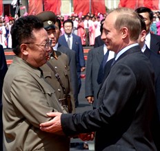 Pyongyang, july 20, 2000, russian president vladimir putin (right) seen being welcomed by north korean leader kim jong i!, asa he arrived in the north korean capital pyongyang on wednesday.
