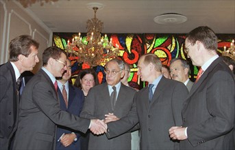 New york, usa, september 9, 2000, russian president vladimir putin shaking hands with chief of the tyumen oil company, or tnk, semyon kukes, at the signing of an accord by the tnk and the u,s, export-...
