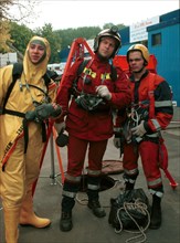 (left to right) mikhail sysoyev, vadim mikhailov (leader of the organization diggersof planet underground), and roman shkryabenkov exhibiting their professional services at the 'state of rescue, 2000'...