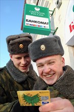 Contract servicemen get salary from an atm cash machine, murmansk, russia, february 20, 2006.