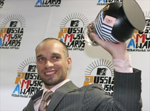 Legalize' holds up a trophy after winning the best hip-hop/rap/r'n'b act award at the 2006 mtv russia music awards ceremony, september 22, 2006.