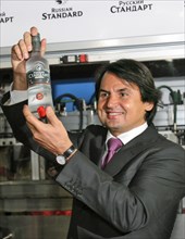 St,petersburg, russia, october 2, roustam tariko, owner of the russian standard brand, chairman of russian standard bank, holds a bottle of russian standard vodka during the opening of the vodka plant...