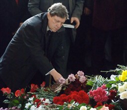 Yabloko party's chairman grigory yavlinsky lays flowers at the coffin of slain russian journalist anna politkovskaya during her burial at troyekurovskoye cemetery, moscow, russia, october 10, 2006.