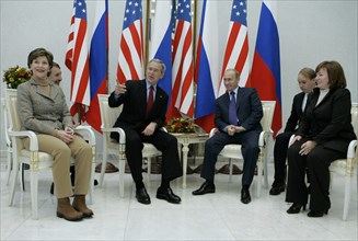 U,s, first lady laura bush, u,s, president george bush, russian president vladimir putin, and russian first lady lyudmila putina, l-r, foreground, smile at a meeting at the vnukovo 2 airport, moscow r...