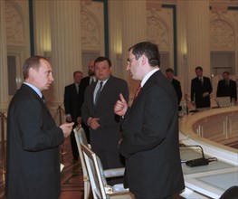 President vladimir putin pictured talking with mikhail khodorkovsky ,the board chairman of the 'yukos' oil company, prior to a meeting with members of the russian union of industrialists and entrepren...