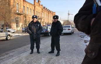 Chita, russia, february 7, 2007, police officers stand guard outside the ingoda regional court building where a hearing has been held to consider mikhail khodorkovksy's continued detention, and a comp...