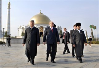 Ashgabat, turkmenistan, february 15, 2007, russian prime minister mikhail fradkov (c) walks after visiting the grave of president of turkmenistan saparmurat niyazov at the mosque called spirit of turk...