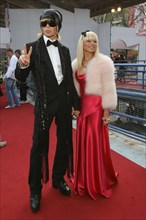 Stylist sergei zverev (l) and his companion pose for a photograph outside the pushkinsky cinema in moscow, the venue of the 2006 mtv russia film awards.