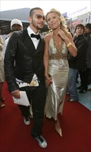 Russian rap singer timati and tv host ksenia sobchak strolling up the red carpet before the mtv russia film awards in moscow’s pushkinsky cinema, april 19, 2007.