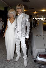 Stylist and singer sergei zverev (r) and his companion at moscow's oktyabr cinema where quentin tarantino's highway thriller death proof received its russian premiere, june 5, 2007.