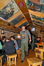 Waiter serving drinks at kryivka, a new cafe with the decor of a upa (ukrainian insurgent army) bunker, in the city of lvov (lviv), western ukraine, october 2007.
