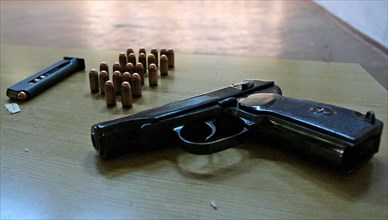 A makarov pistol on a table at a shooting range during a marksmanship competition in russia.