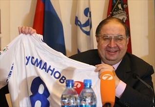 Moscow, russia, february 27, 2008, russian billionaire alisher usmanov who controlls metalloinvest industrial holding company, poses with a jersey bearing his name at a press conference marking metall...
