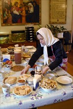 A nun lays the table for meagre dinner in a frater of the nativity of the holy virgin cathedral in chernogorsk during the lent, krasnoyarsk territory, russia, march 20, 2008.